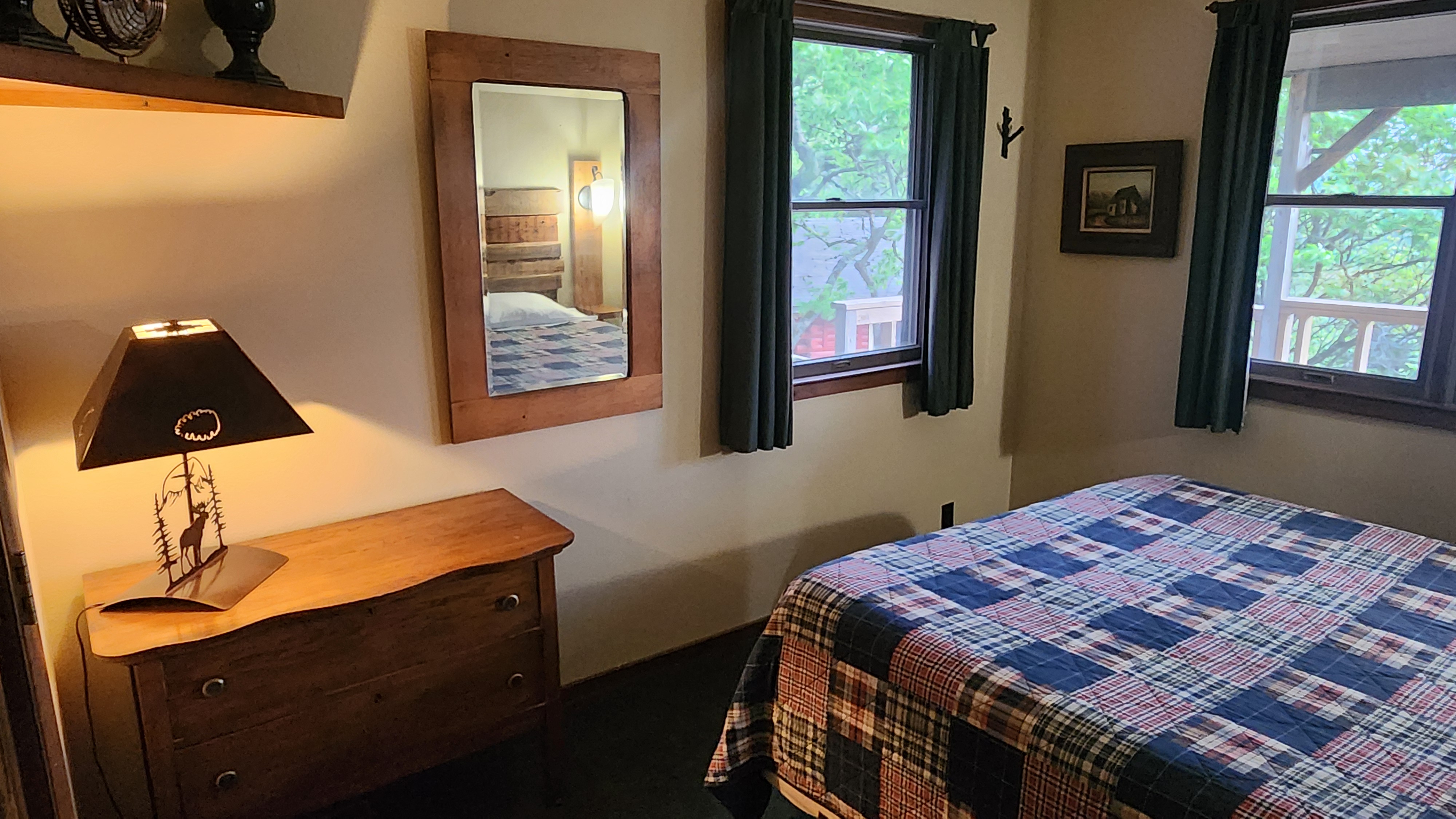 Valley View master bedroom showing dresser, mirror, and deer silhouette lamp