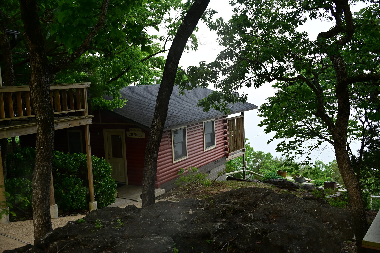 Log cabin built right onto the natural limestone rock of the bluff
