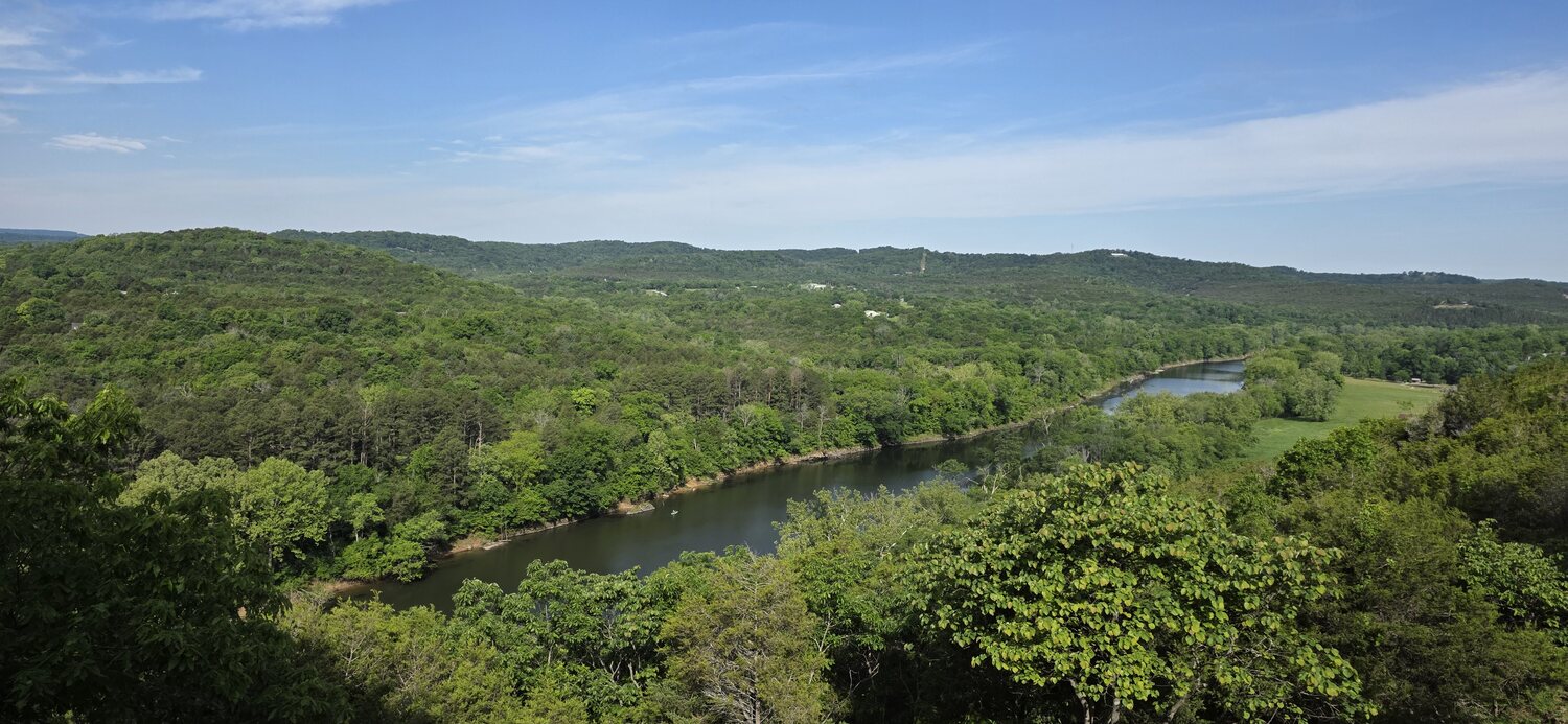 Panoramic view of the green Ozark valley with the White River winding through it on a clear morning