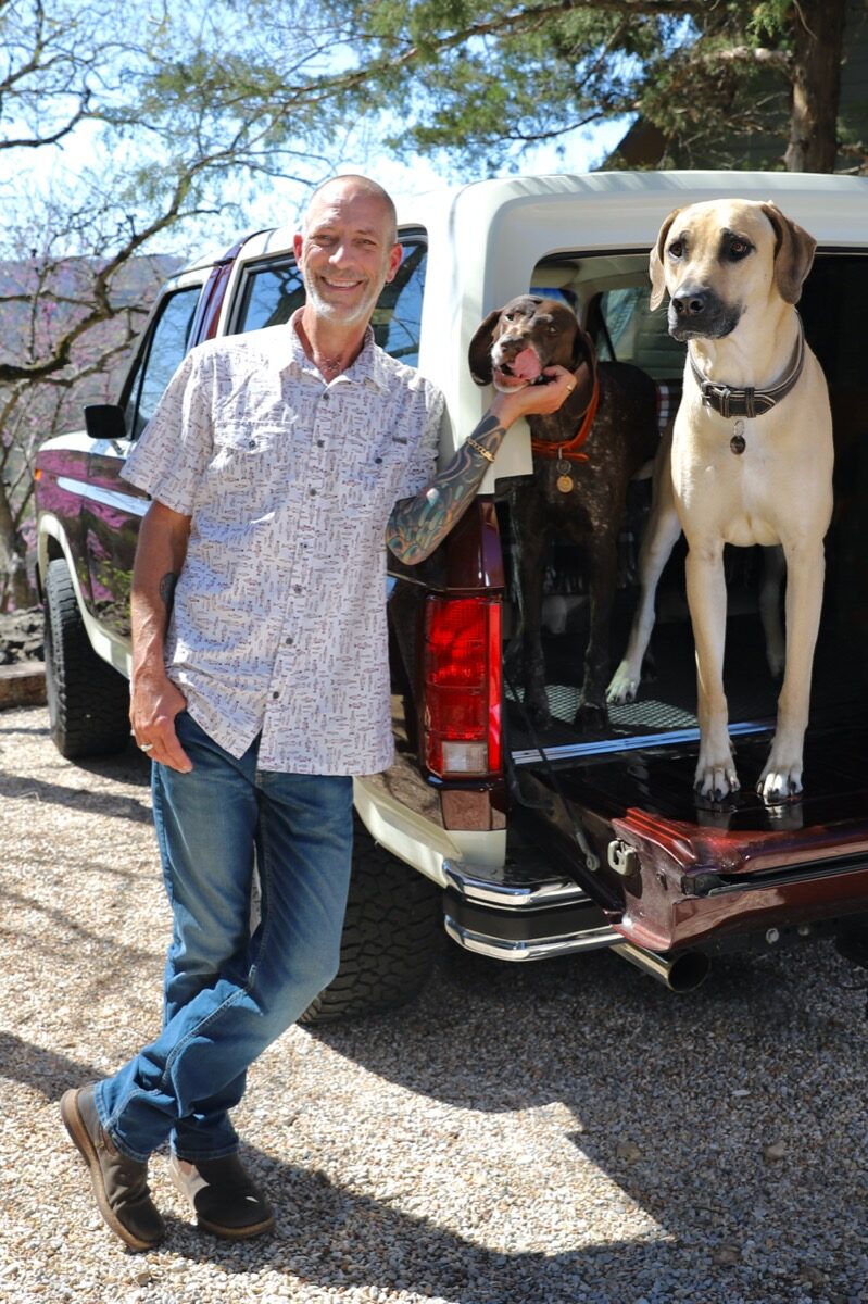 Art and Amy on the property with the vintage wagon and chickens